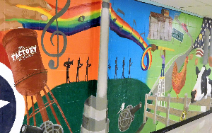     A mural in Page High School with various images, such as farm animals and the Tennessee state fl